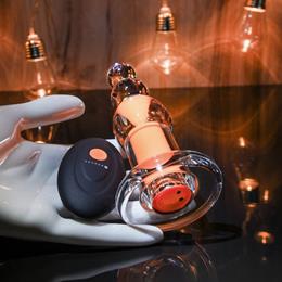 Plug Anal Recarregável Transparente com Cápsula Interna, 10 Modos de Vibração e Controle Remoto - Gender X Orange Dream | 10 x 3,5 cm