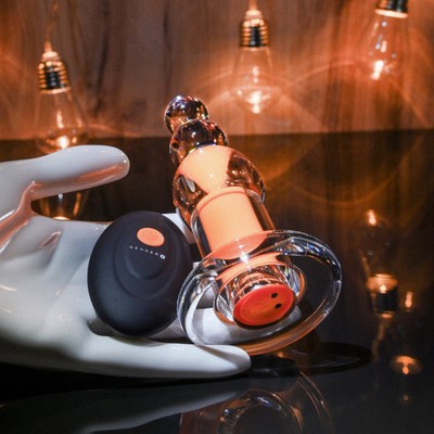 Plug Anal Recarregável Transparente com Cápsula Interna, 10 Modos de Vibração e Controle Remoto - Gender X Orange Dream | 10 x 3,5 cm